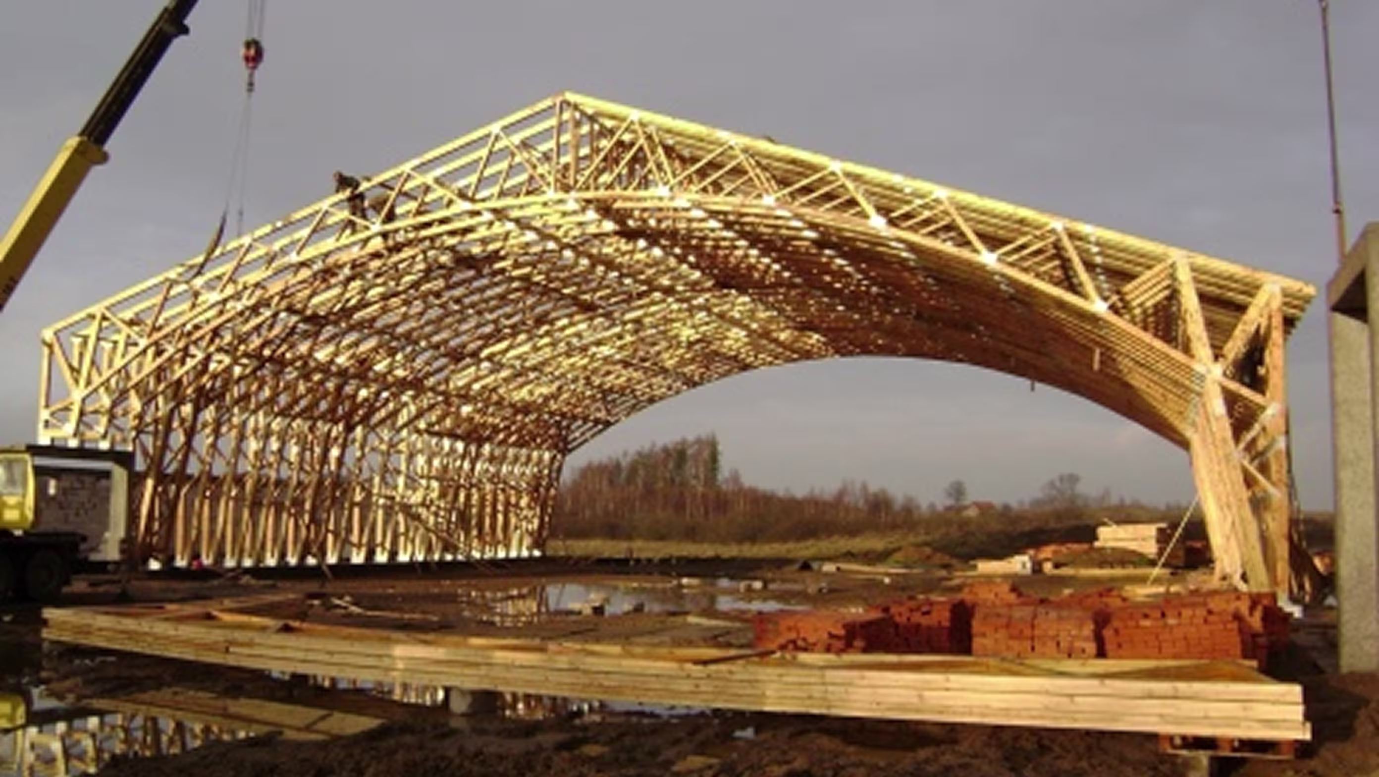 Large wooden hangar structure under construction