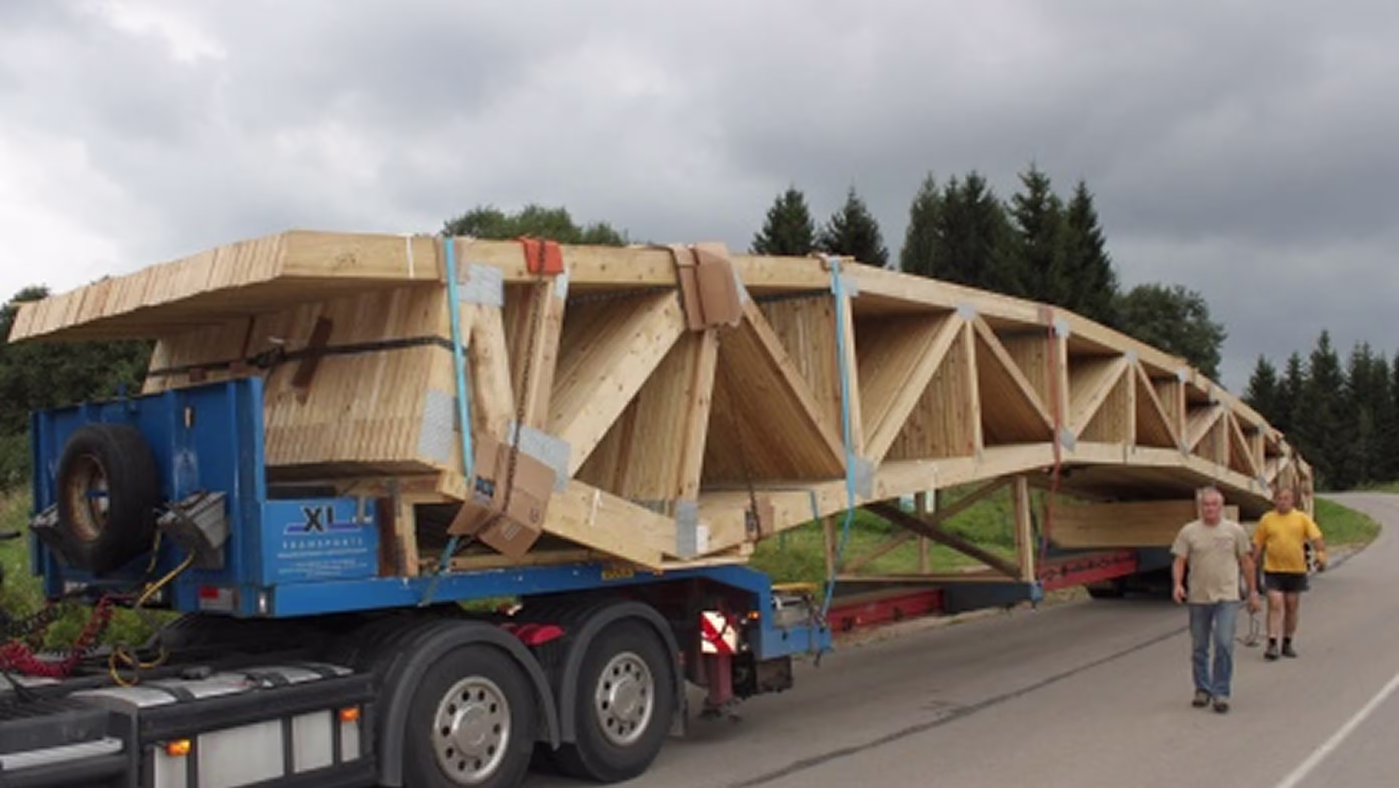Truck transporting large timber truss component